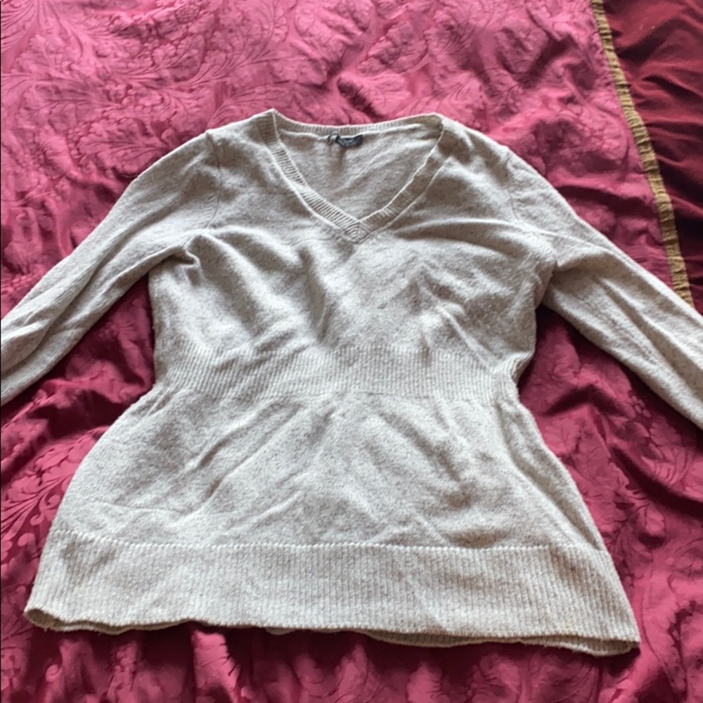 Long v-neck sweater cinched at waist